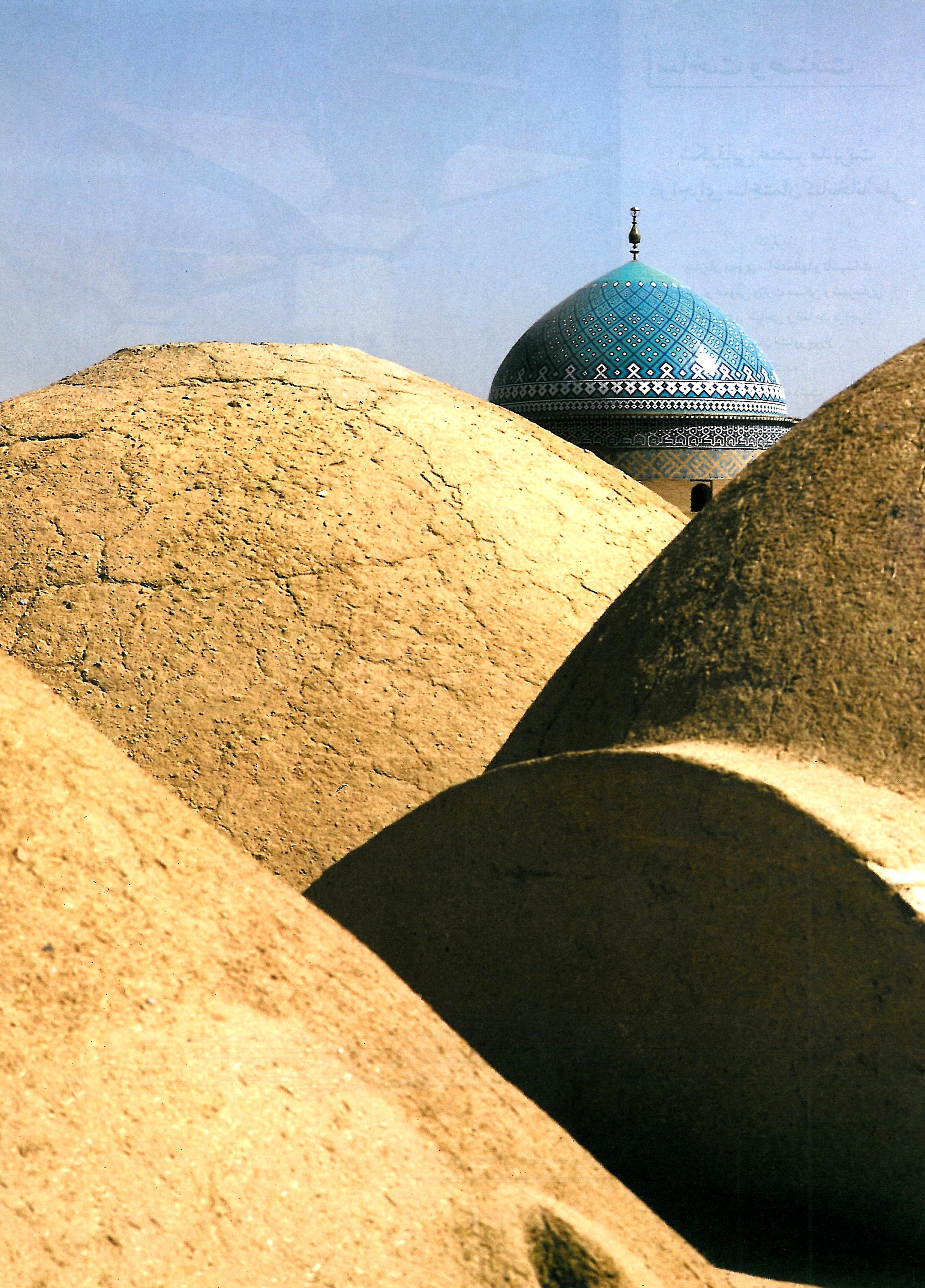 Domed roofs with the tiled mosque dome on the horizon