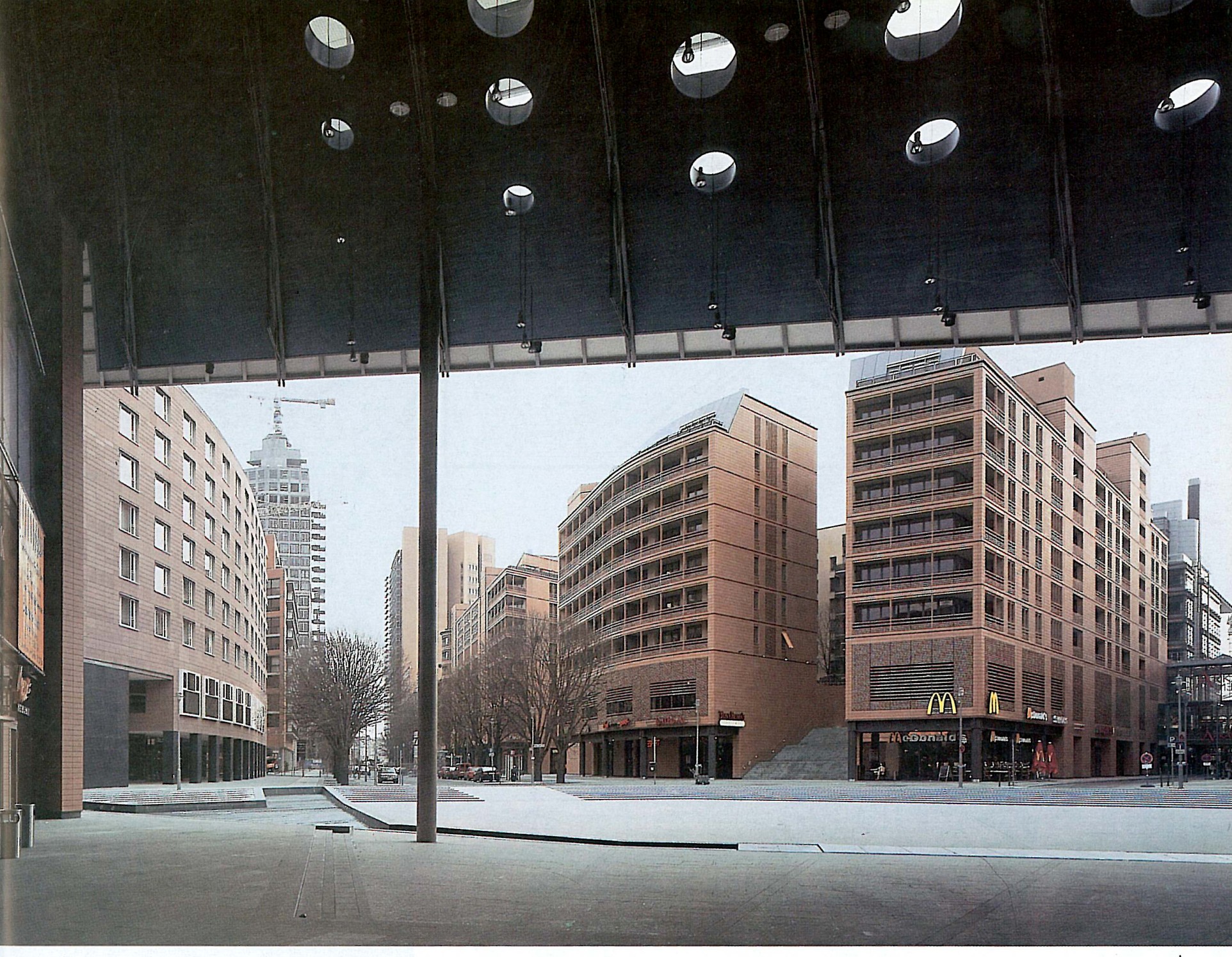 Plaza panorama looking out from under one of Isozaki's gateway buildings, with the mid-rise blocks on the right