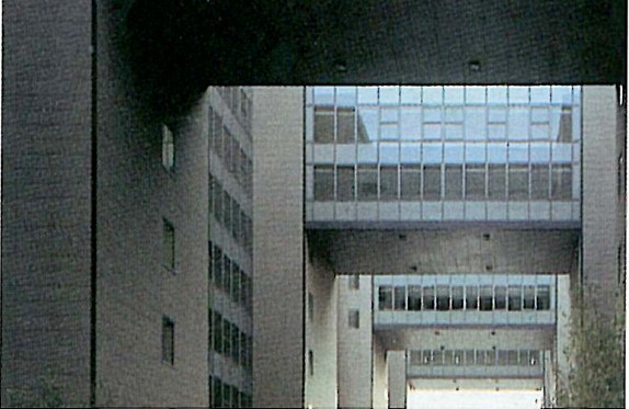 Close-up of the brick-clad Isozaki gateway between two blocks
