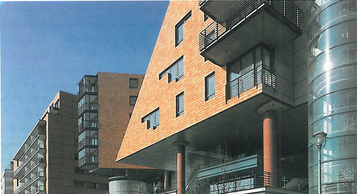 Triangular cutout view through one of the residential blocks toward the plaza beyond