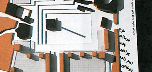 Top-down photograph of a cardboard urban-design model showing terraced restored buildings around the Imamzadeh shrine precinct.