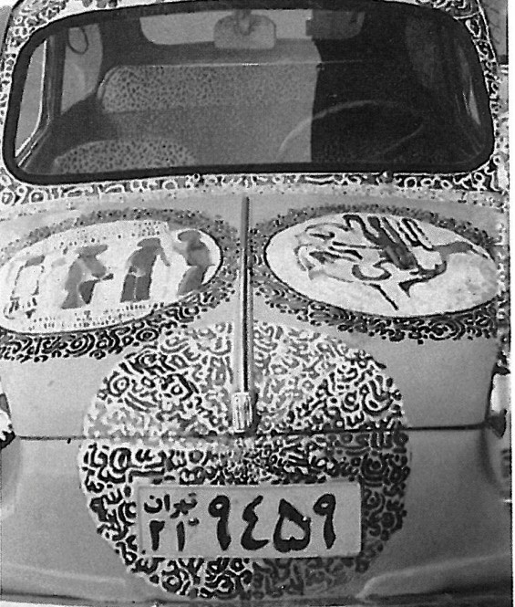 Photograph titled 'The end': calligraphy-painted rear of a sedan parked in sunlight, with two circular medallion designs above a Tehran-plated bumper covered in Persian-script ornament.