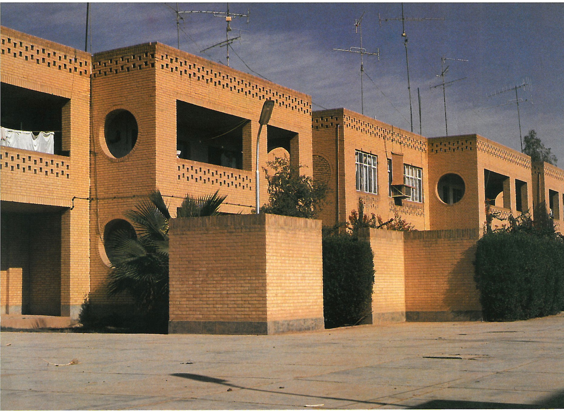 Jondi-shapur University Houses: yellow-brick residential terraces with circular openings