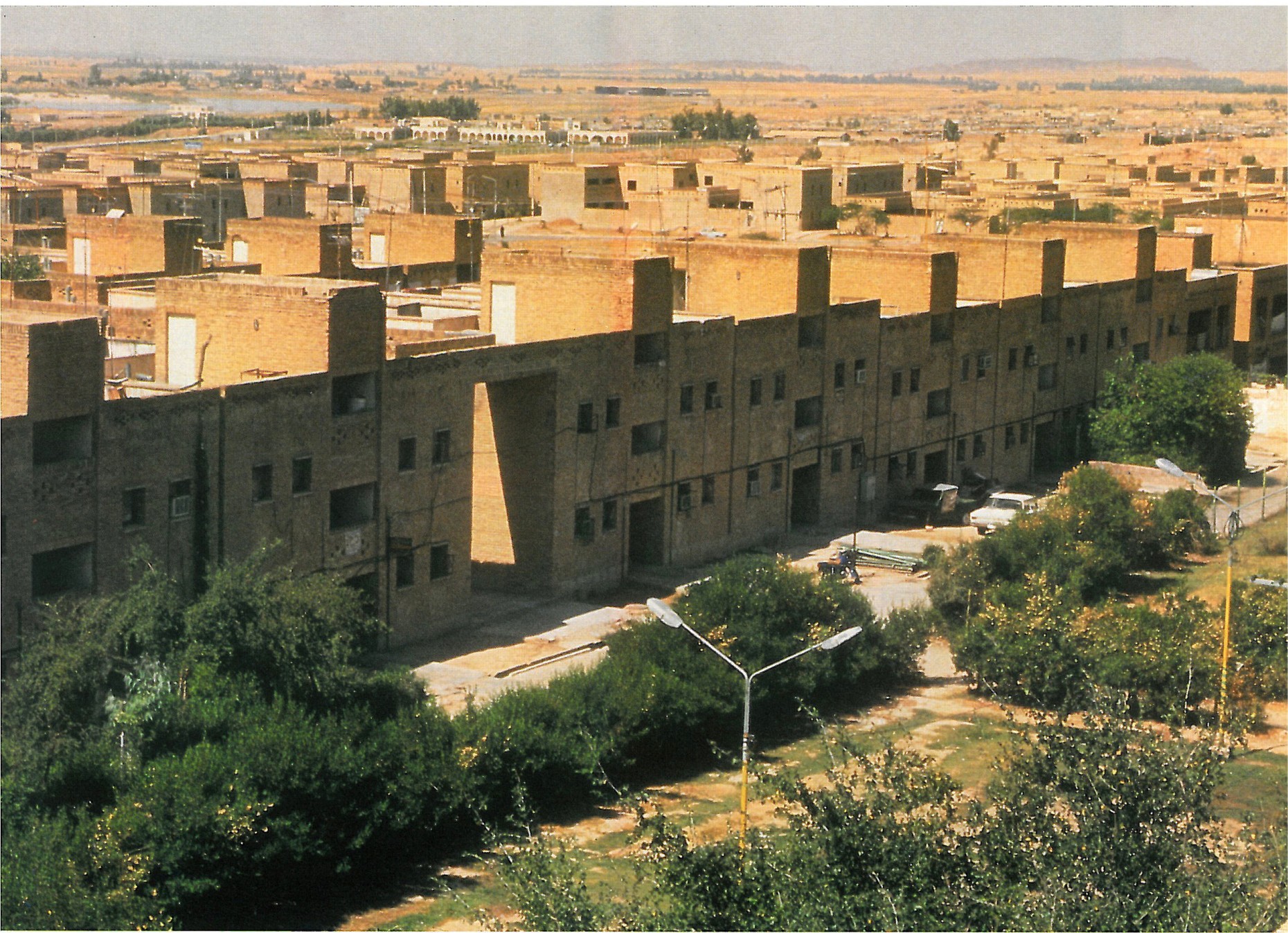 Aerial view of Shushtar New Town: low-rise brick housing rows in the desert landscape