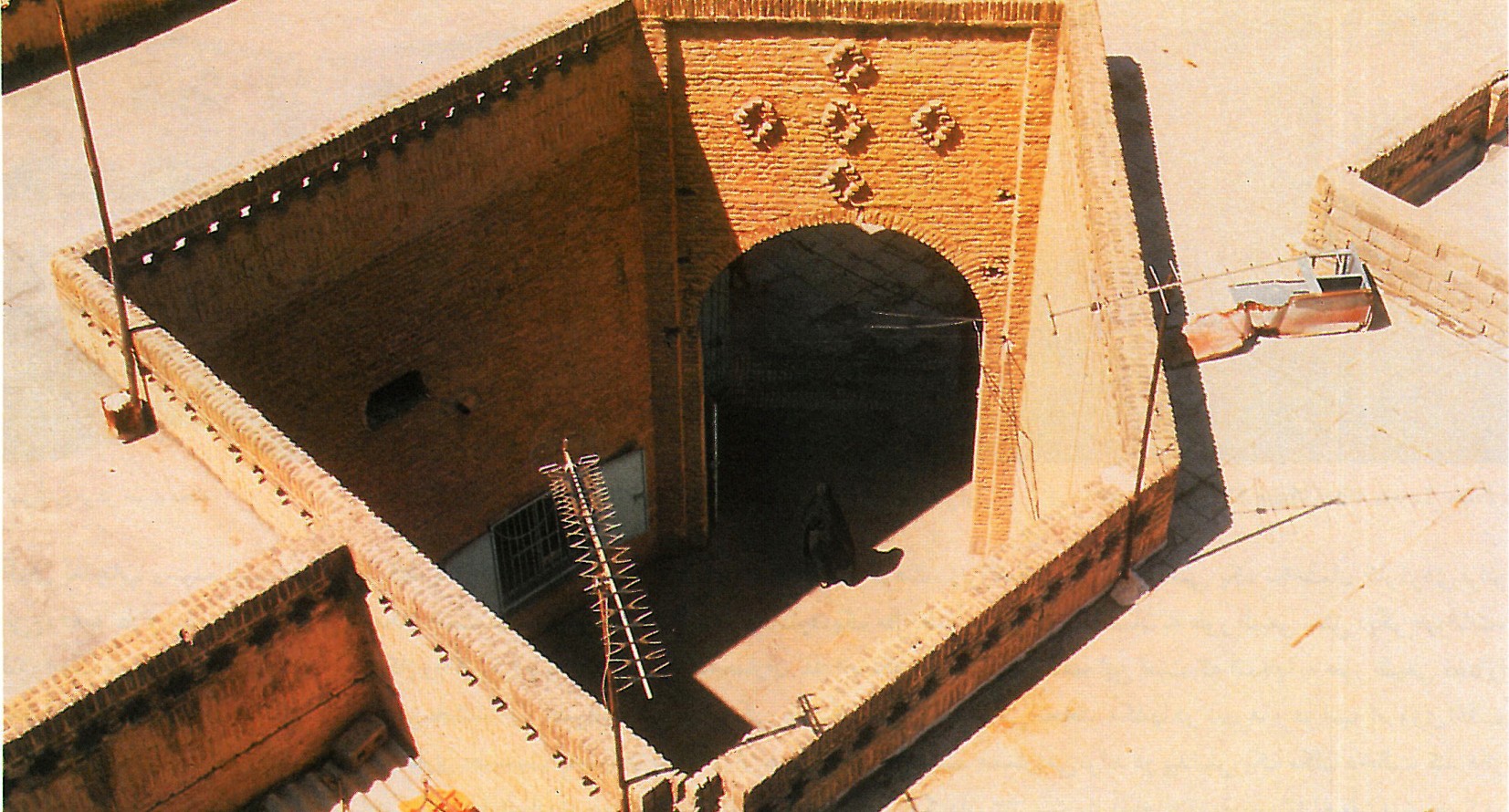 Entrance to the Friday Mosque at Shushtar New Town: pierced brick walls and angled stair into the courtyard
