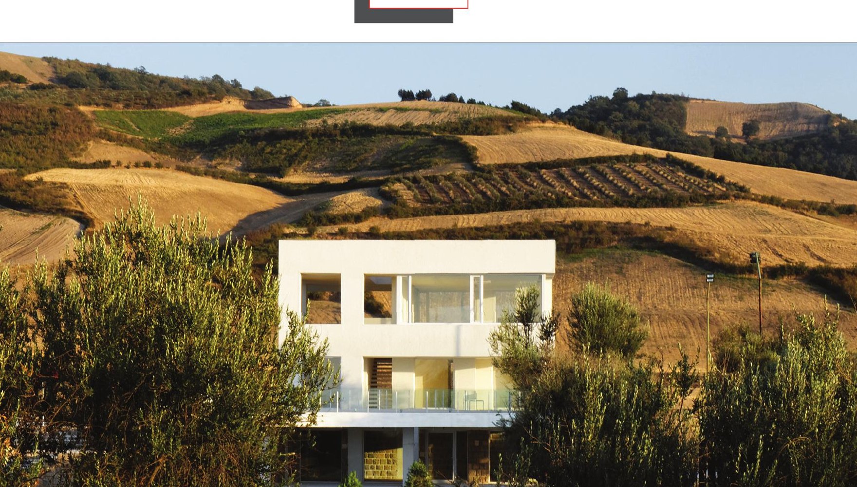 Distant view of Cheshm Cheran Villa nestled among olive trees at the foot of the bare Minoudasht hills