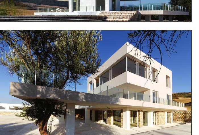 Cheshm Cheran Villa from the olive grove showing the layered plastered volumes and the stair access to the platform