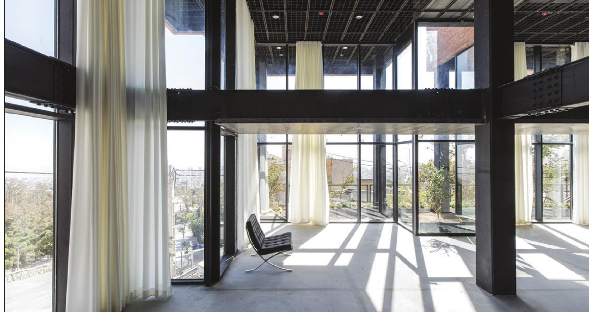 Bright interior with full-height glazing onto a balcony
