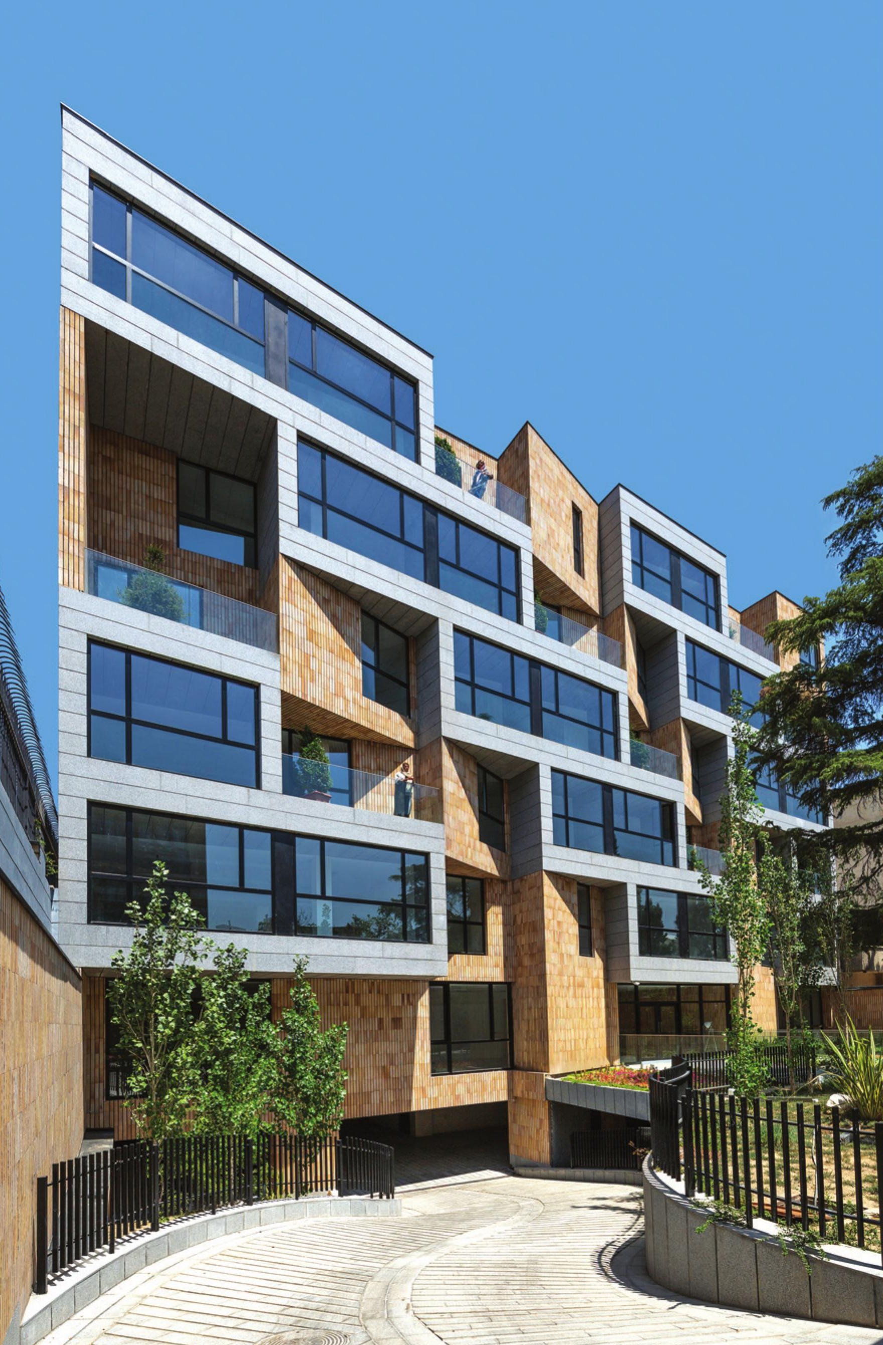Golestan Residential Building — five-storey faceted facade with white stone bands and timber panels