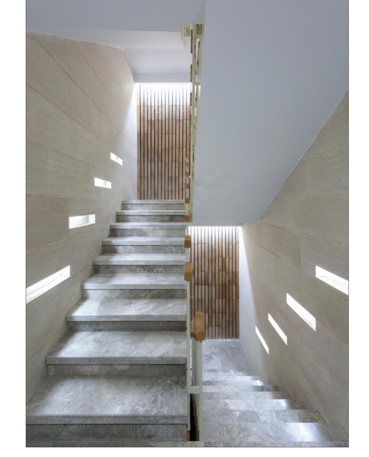 Top-lit stair core looking up through stacked landings