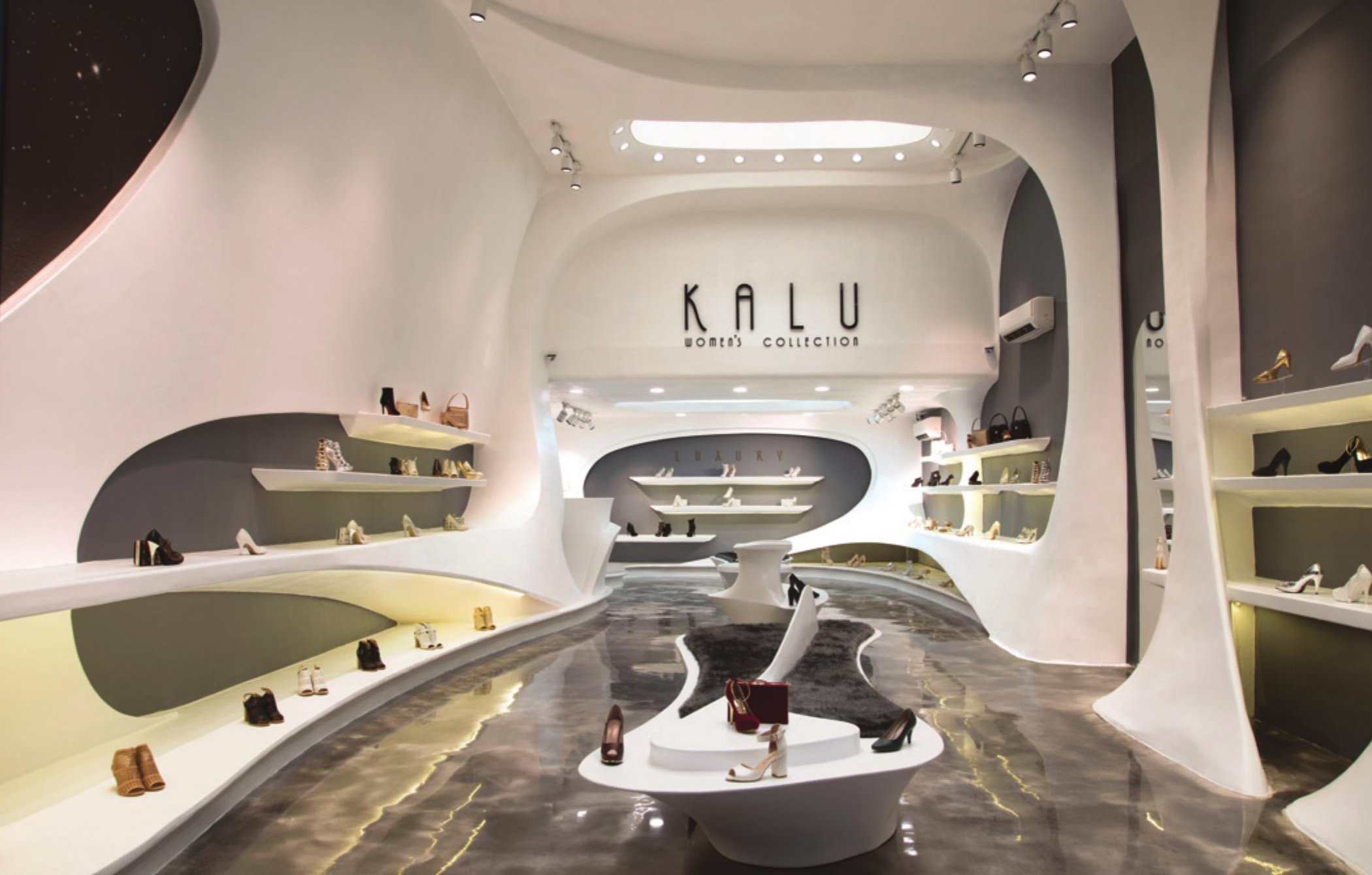 Cream-coloured interior with shoes displayed in niches