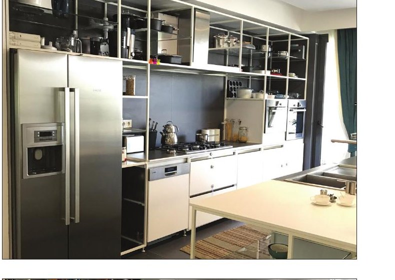 Manzarieh interior — open kitchen with stainless fridge and white modular shelves