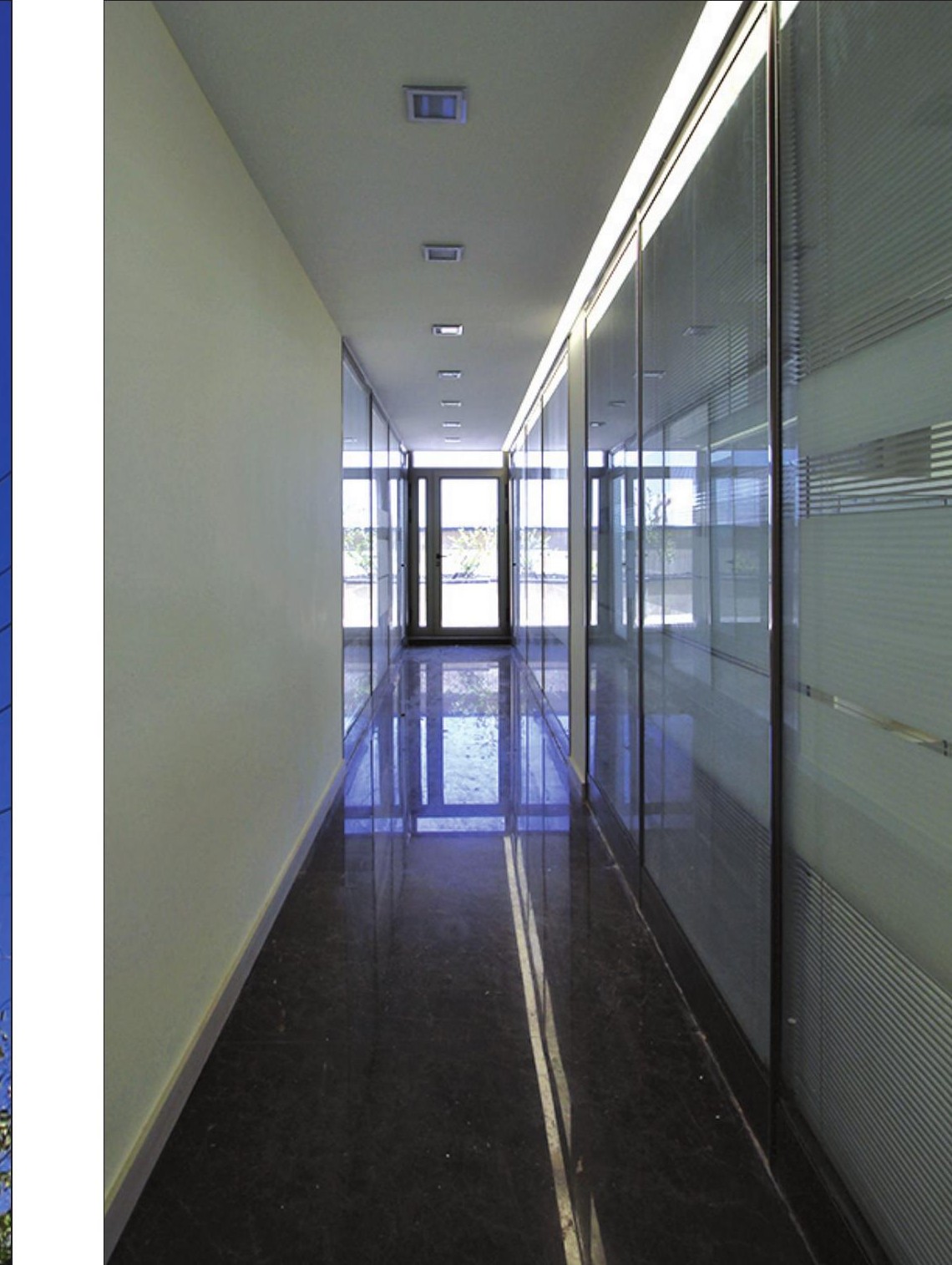 Office corridor with full-height glazing along one side