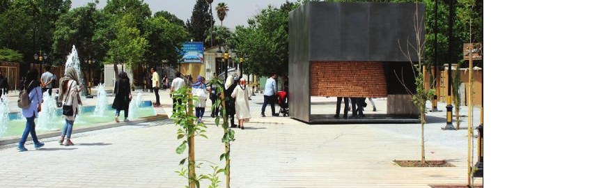 The cube pavilion in a plaza with visitors around it