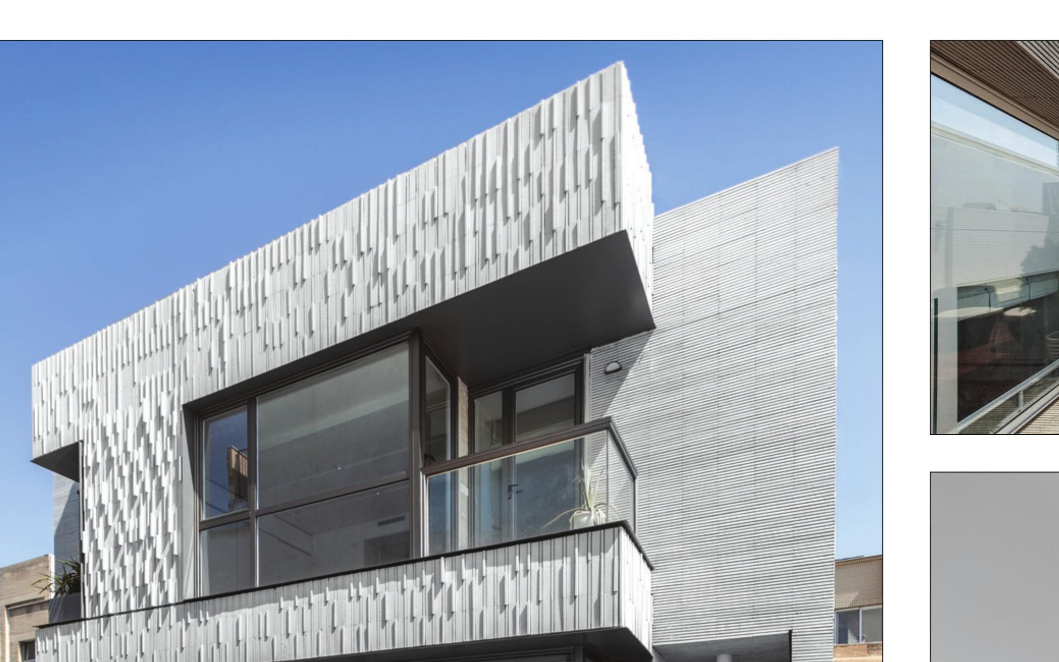 Rokhbar Building — cantilevered glass volume above brick base