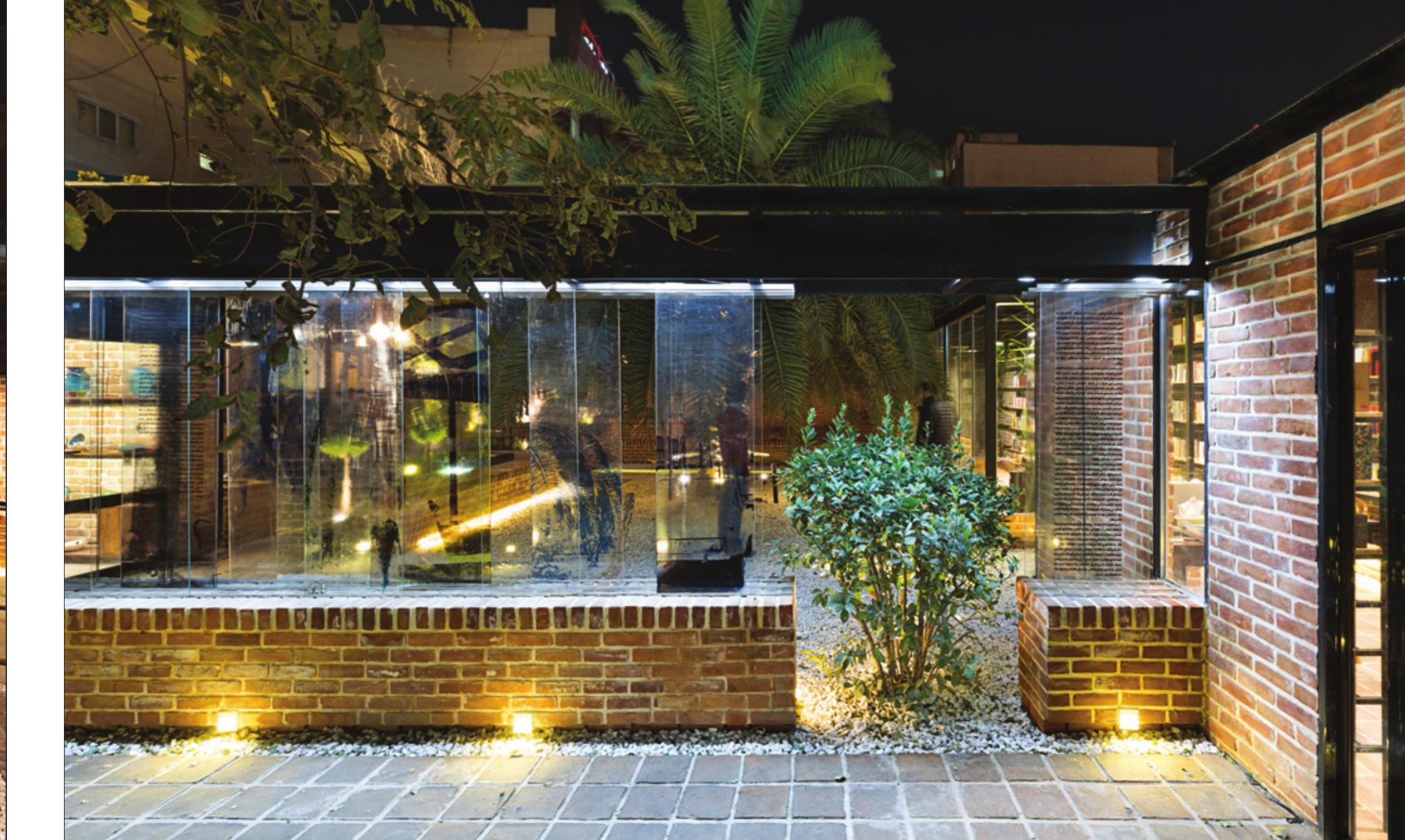 Entrance to the mansion at night, lit from within