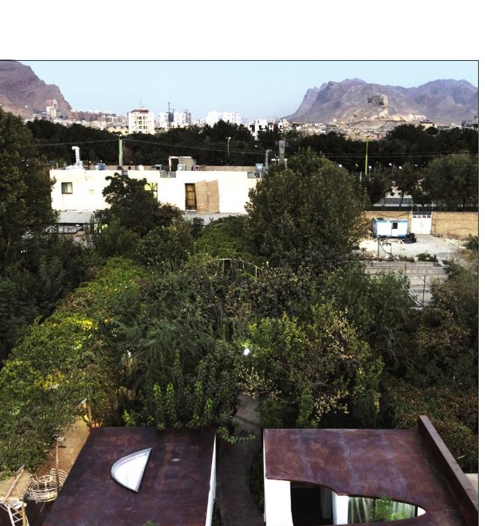 Aerial view of the rusted-steel roofs of At the End of Mohammad Restaurant set in a garden along the Zayanderud