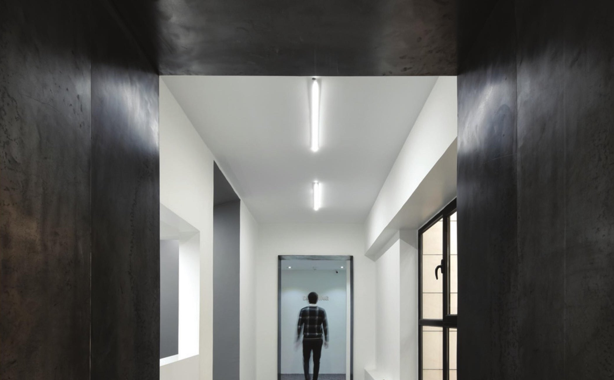 Dark concrete-clad internal corridor