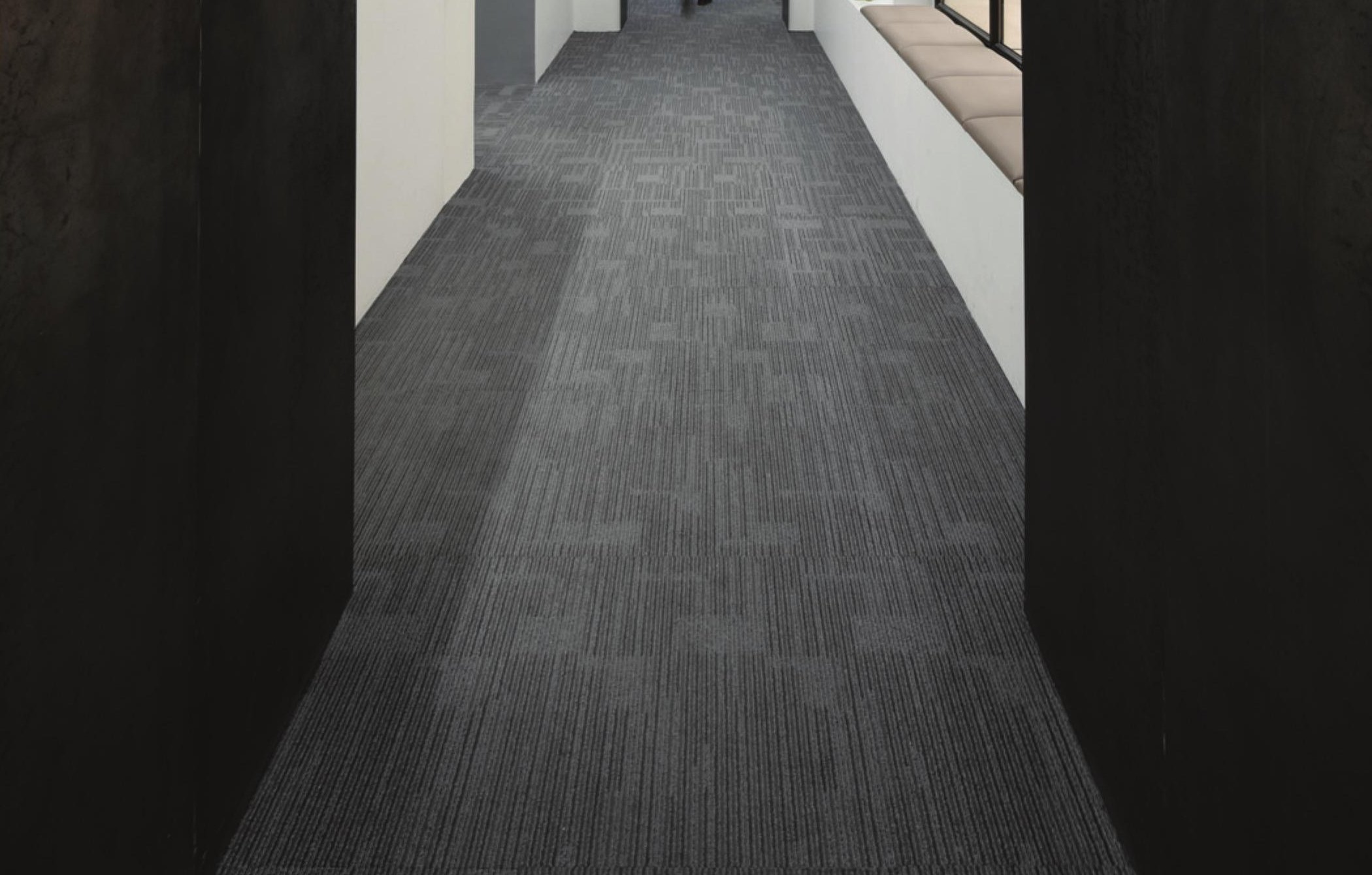 Bright white corridor with people seated