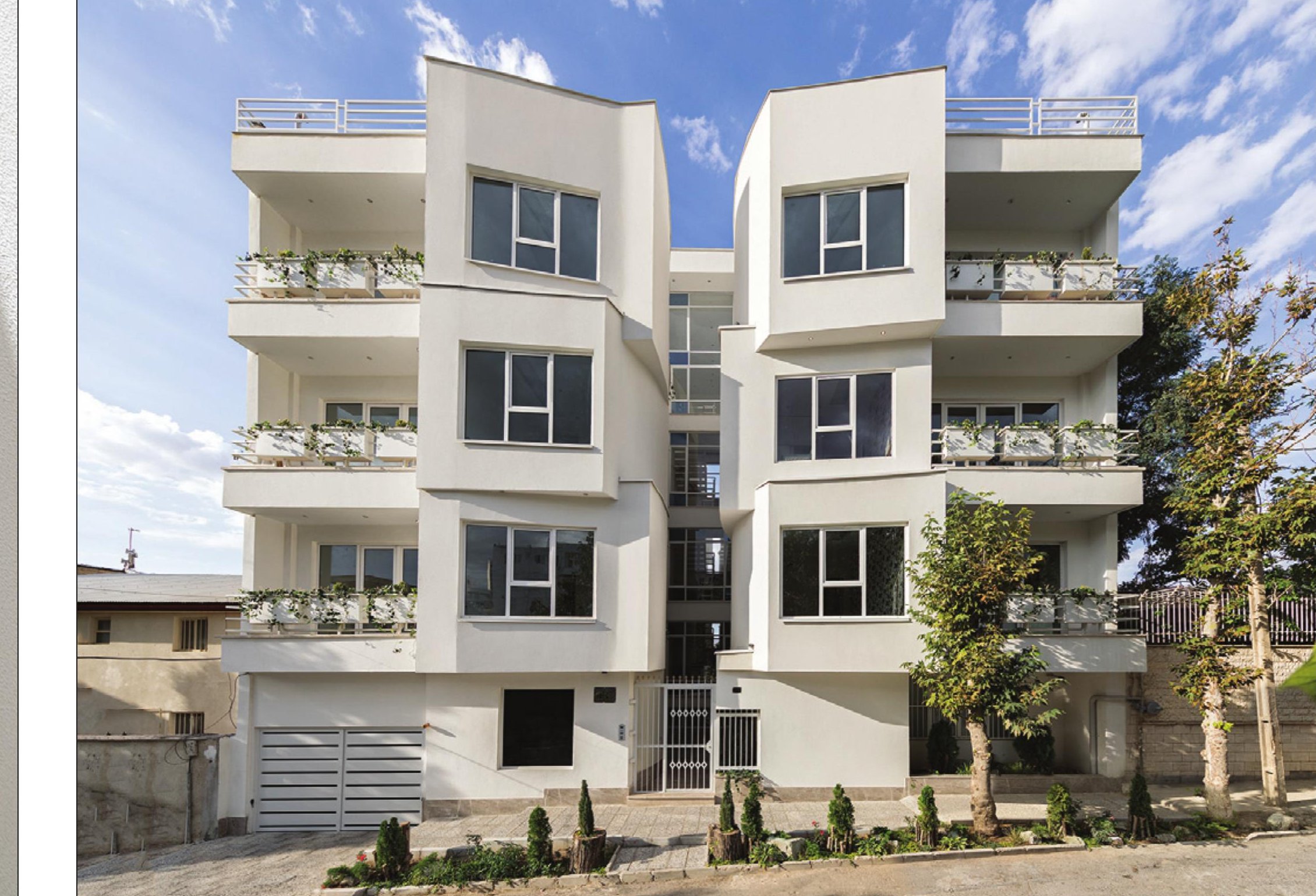 Wide view of the white residential building in its Damavand landscape setting
