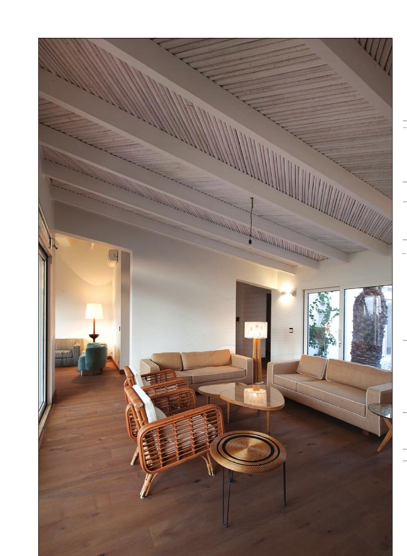 Living room of White House 1 with bamboo-and-plaster ceiling, beige sofas and rattan armchairs