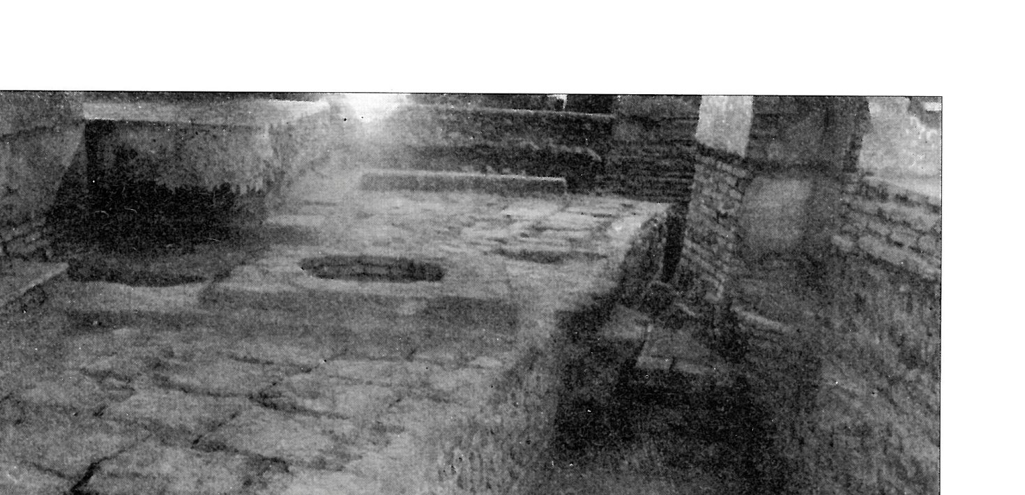A section of the qibla wall of the earliest mosque, whose angle differs from the present wall — uncovered beneath later building layers.
