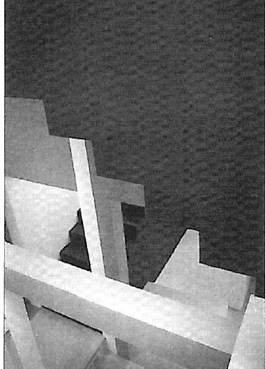 Photograph of a small chipboard architectural model of Hejduk's Wall House on a dark background
