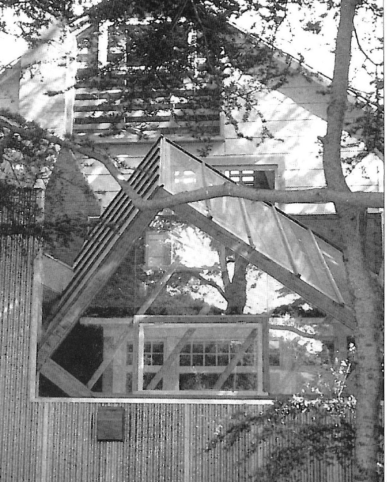 Photograph of a wooden interior space with sloped roof, supporting columns and clerestory windows