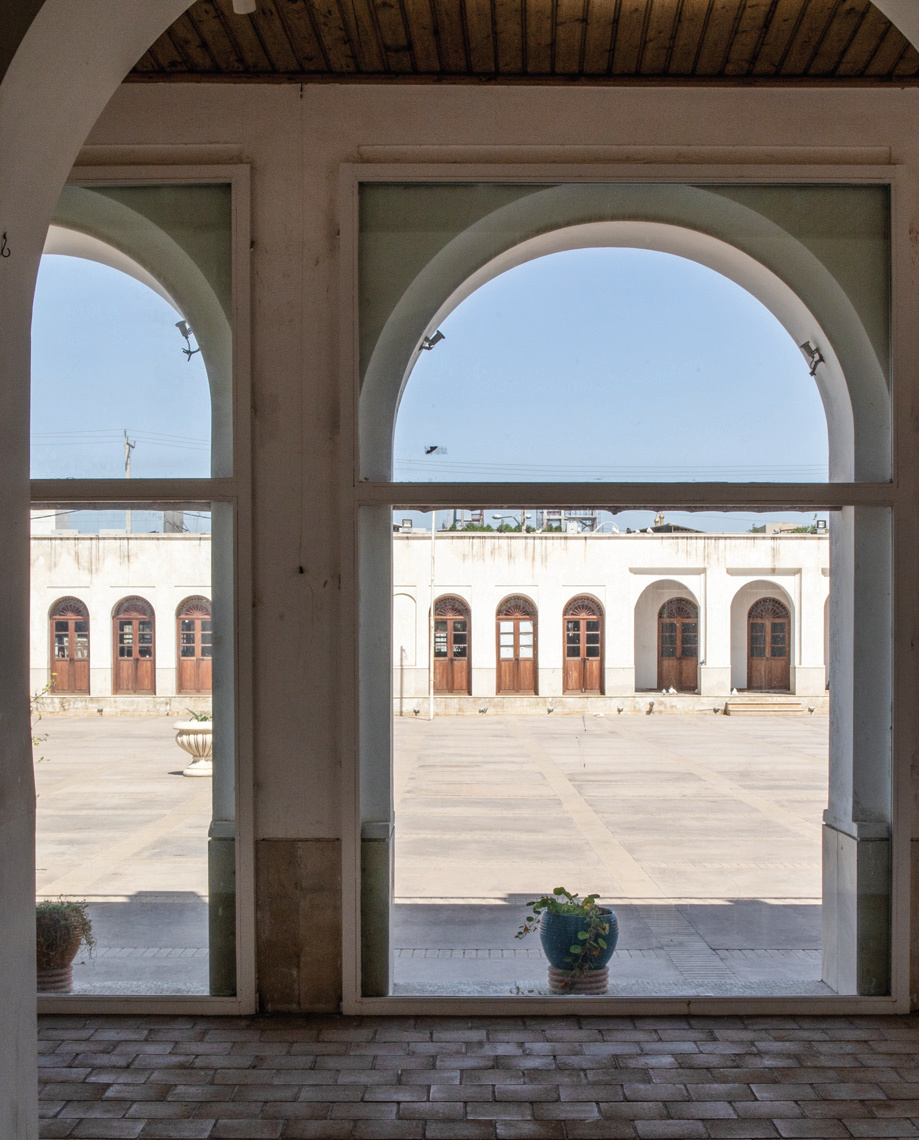 View through triple arches to the courtyard and the opposite wing of the school