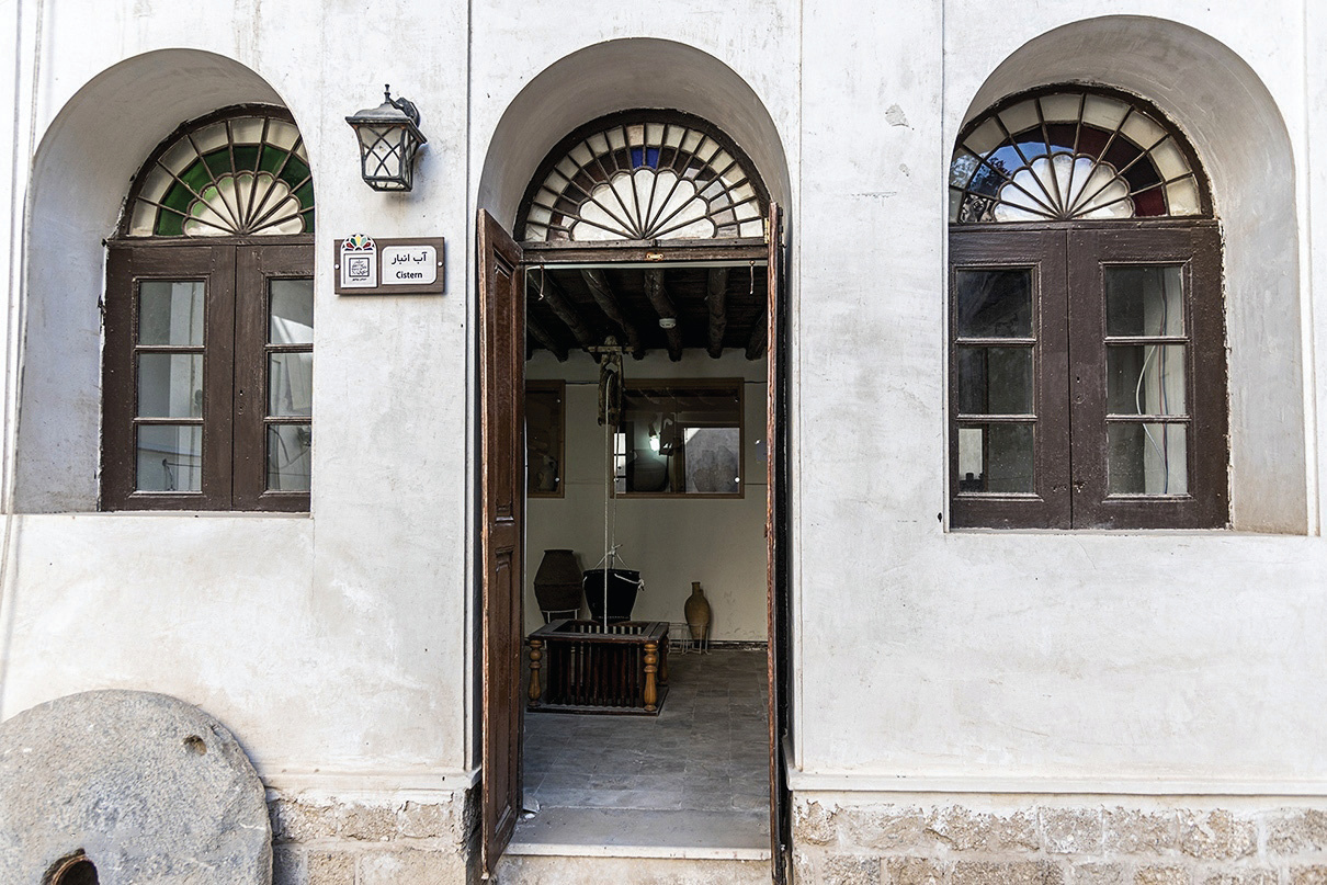 Arched entrance to the cistern room with fan lunettes and a sign reading Cistern