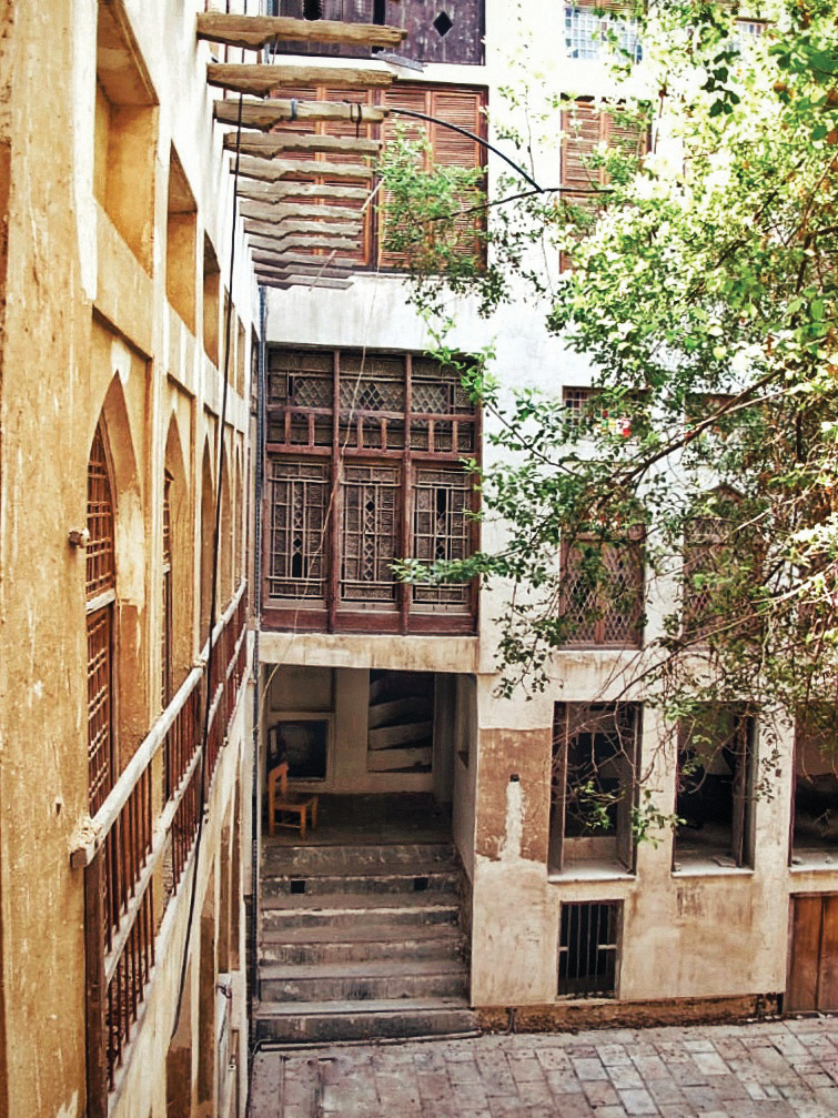 Corner of the courtyard showing multiple stories, stairs, galleries and wooden balconies