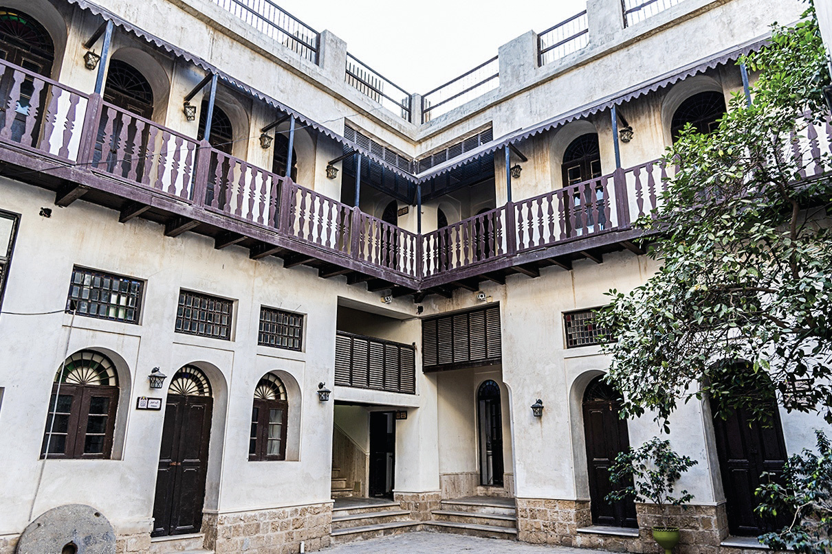 Inner courtyard of the Amirieh Edifice with two-story wooden galleries and arched openings