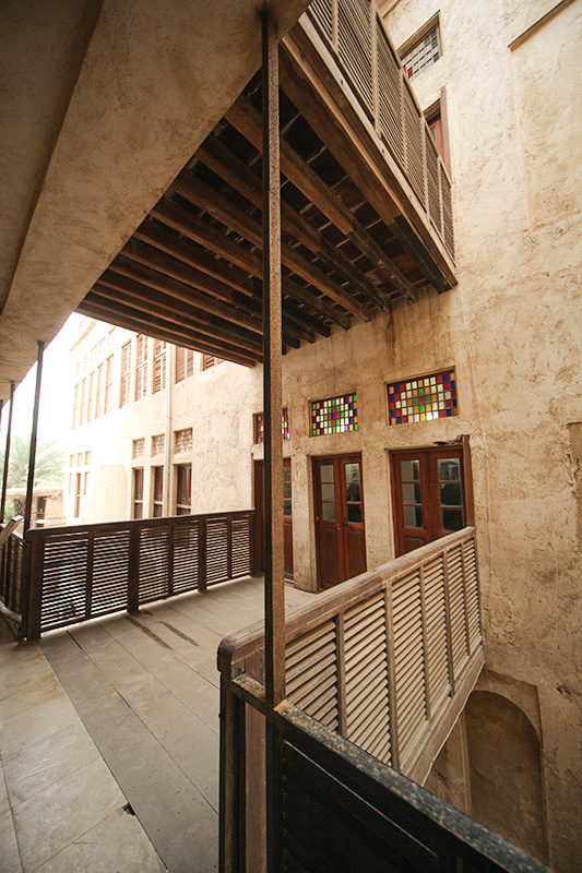 Interior gallery with stained glass windows and wooden canopy overhead