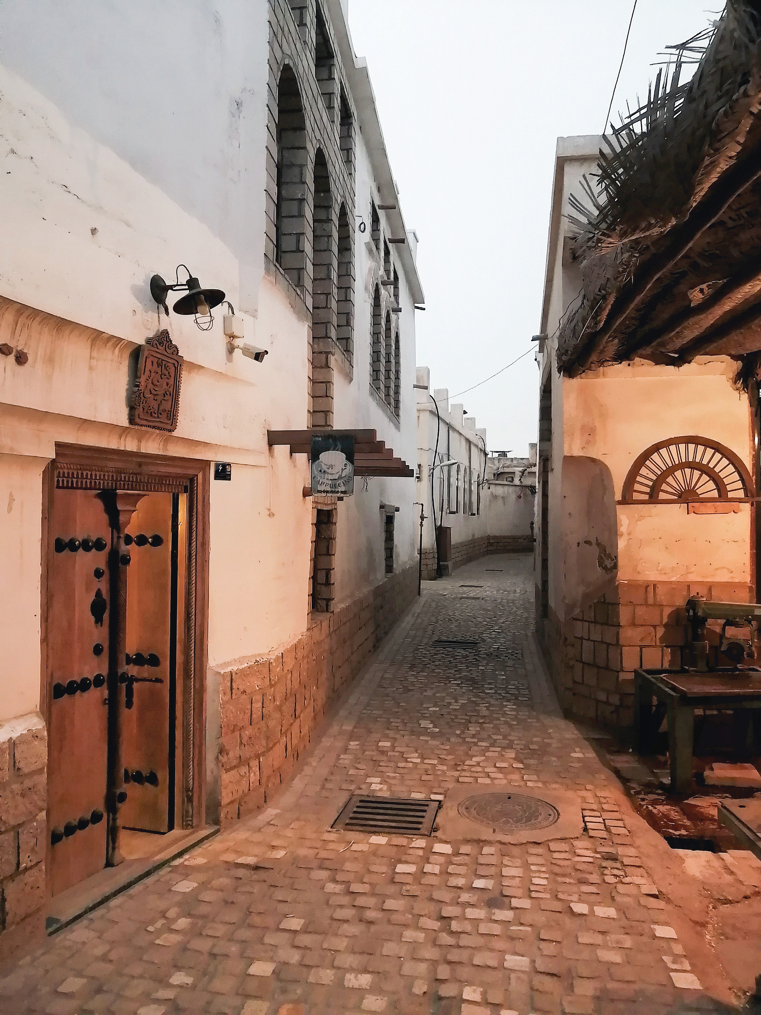 A narrow alley in the historic quarter of Bushehr with traditional doors and architectural details