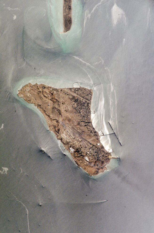 Satellite view of the entirety of Khark Island from above, showing its elongated shape in the Persian Gulf