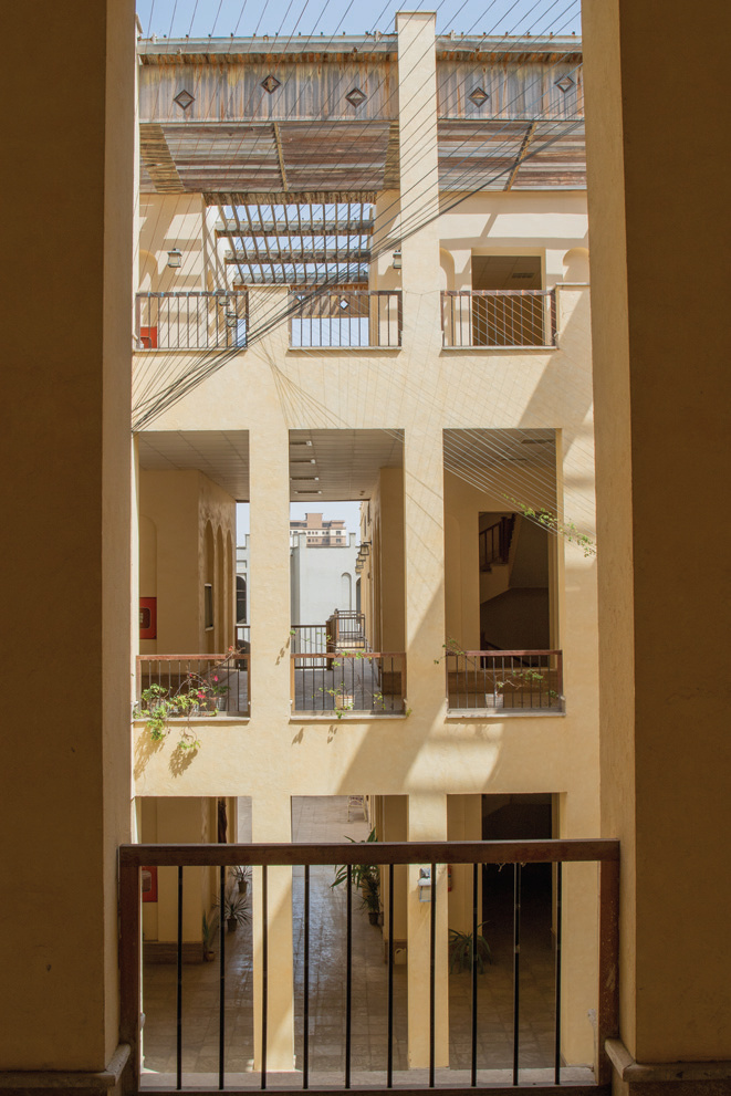 Multi-level courtyard of the new faculty building with modern railings and cable elements