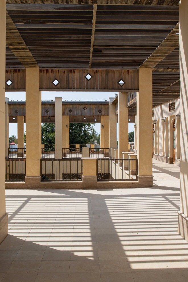 Upper terrace with timber beam canopy, columns with diamond cutouts, and open views
