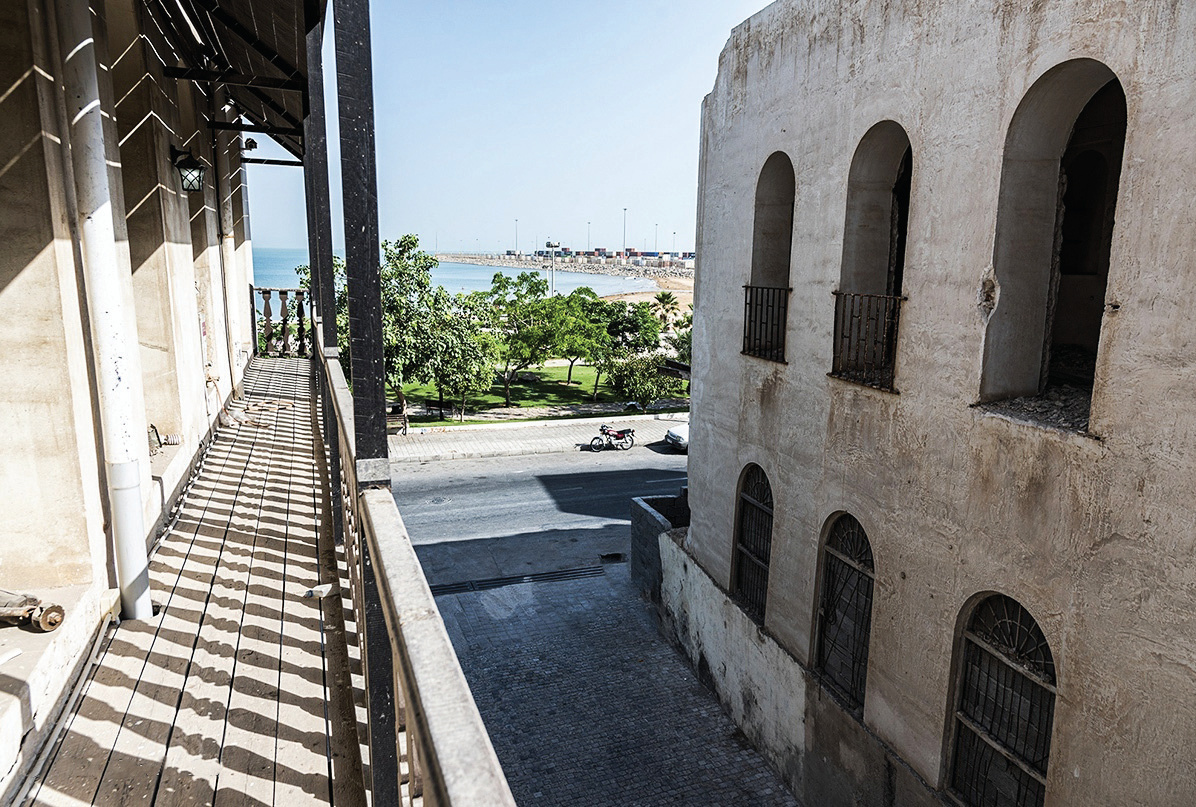 Side balcony with sea view and arched windows on adjacent wall
