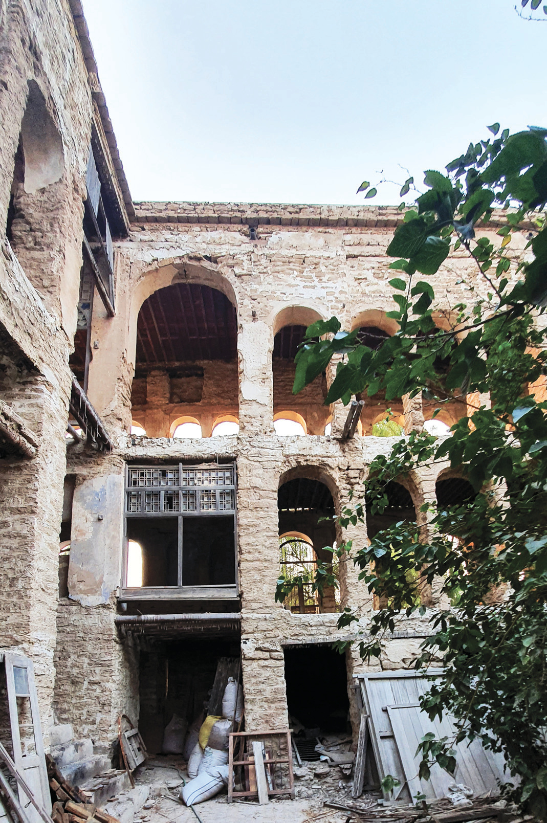 Son's building courtyard with multi-story arched facades