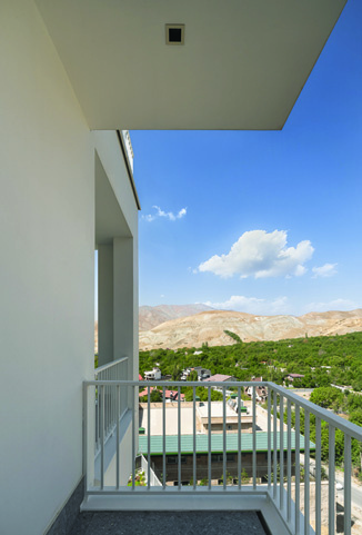 Corner balcony with railing offering a dramatic view of the barren mountains