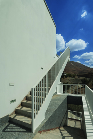 External staircase running along the hillside connecting different levels of the building