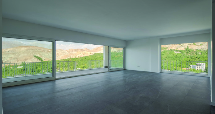 Another living space with wide horizontal windows overlooking the valley and mountains