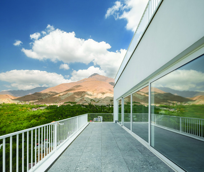 Terrace looking west over the Lavasan landscape with mountains in the background