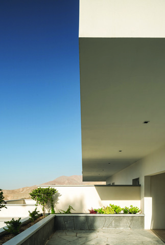 Terrace with a planter box and mountain views, showing the minimal railing design