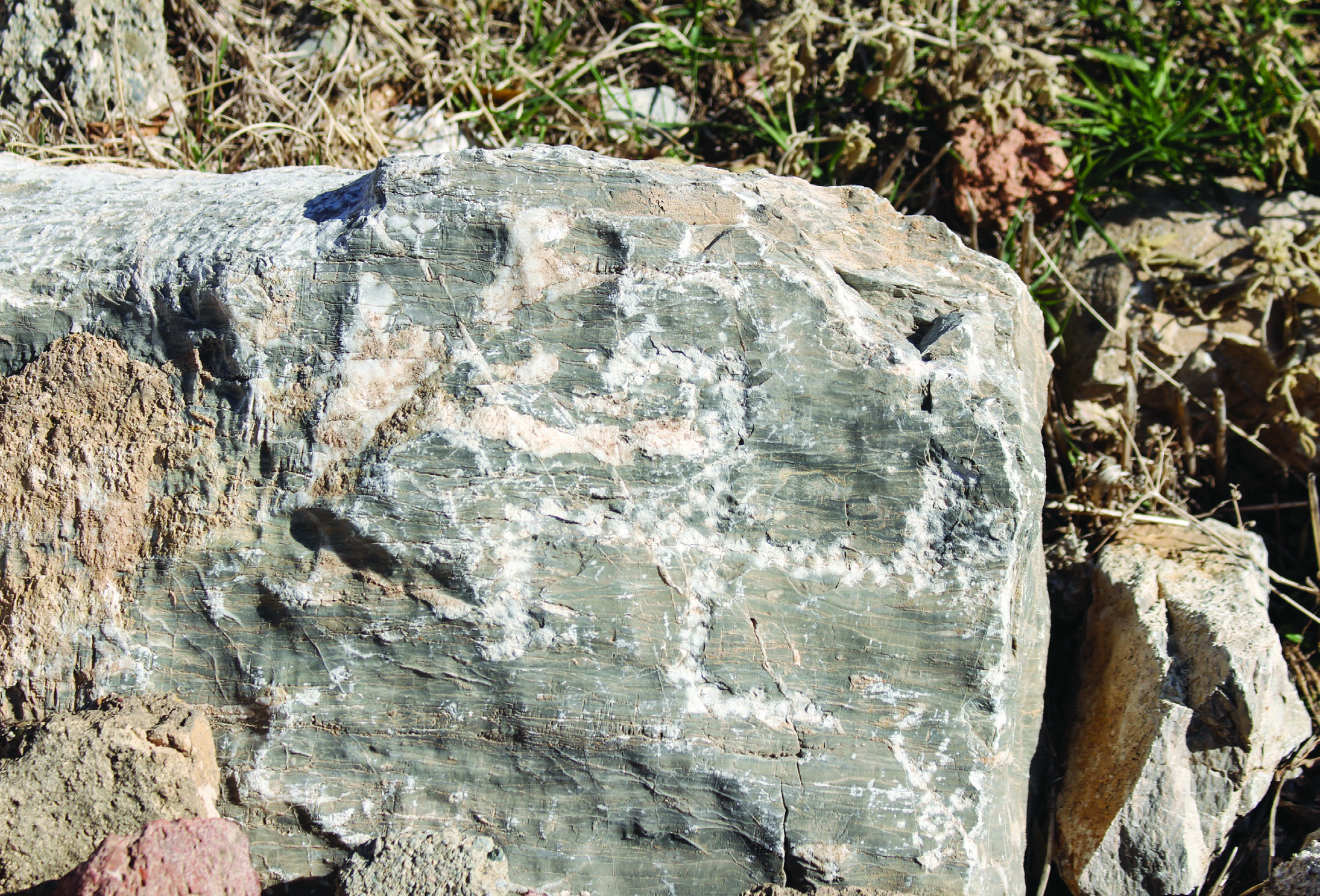 Ancient carved rock shelter with graffiti and cup marks at the Anahita Temple site in Kangavar, Hamedan