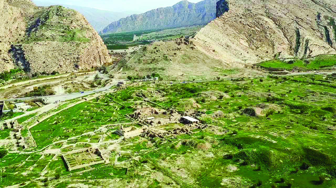 Aerial view of the Bishapur archaeological site showing ruins surrounded by mountains and the natural landscape of the Zagros range
