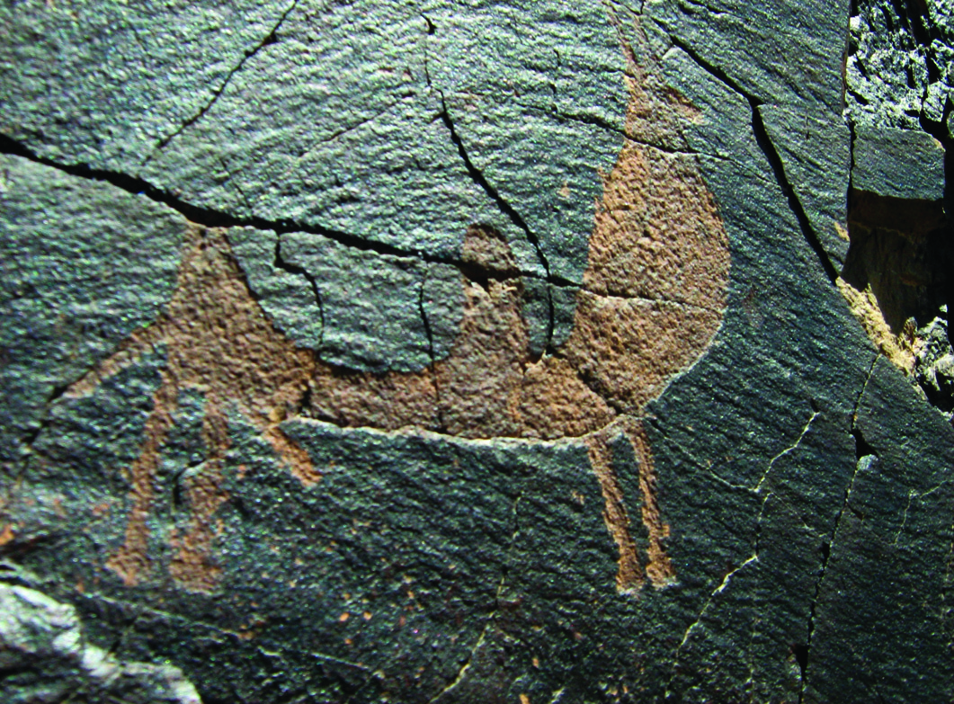 Petroglyph at Darreh Negaran showing a large deer with its calf in ochre-red tones on dark stone