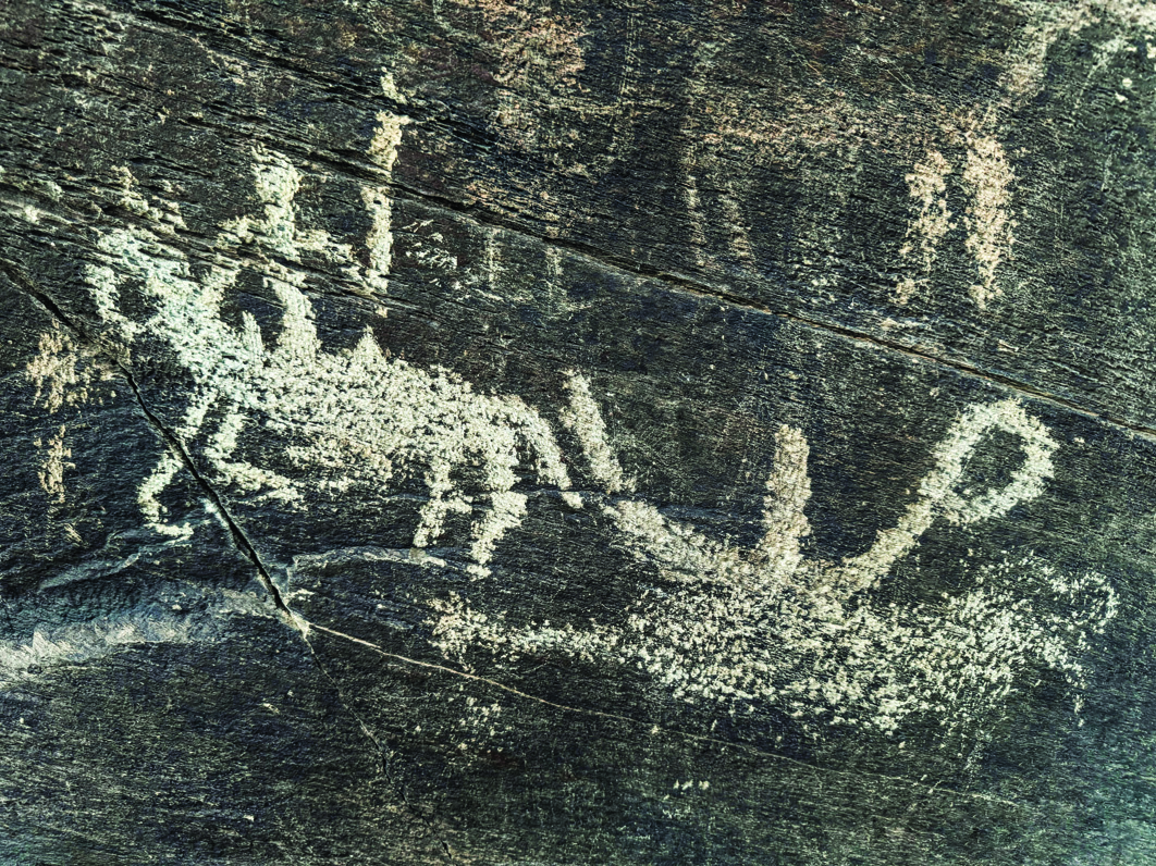 Petroglyph at Darreh Negaran showing human hunters confronting large ibex with long curved horns