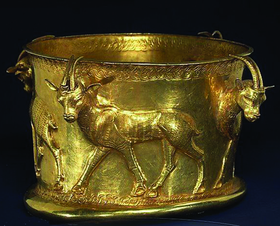 Golden cup from Marlik with embossed bulls walking in procession, featuring three-dimensional bull heads at the rim