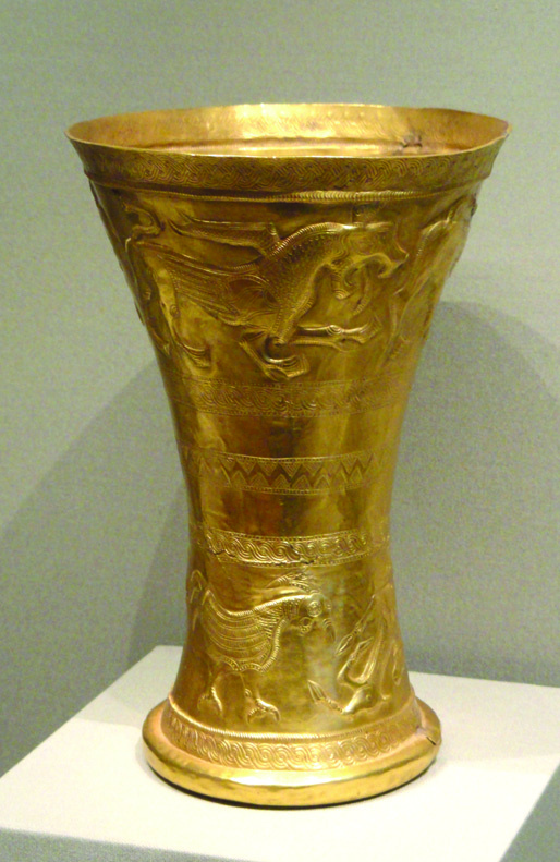 Tall golden goblet from Marlik with winged mythical creatures in repousse relief